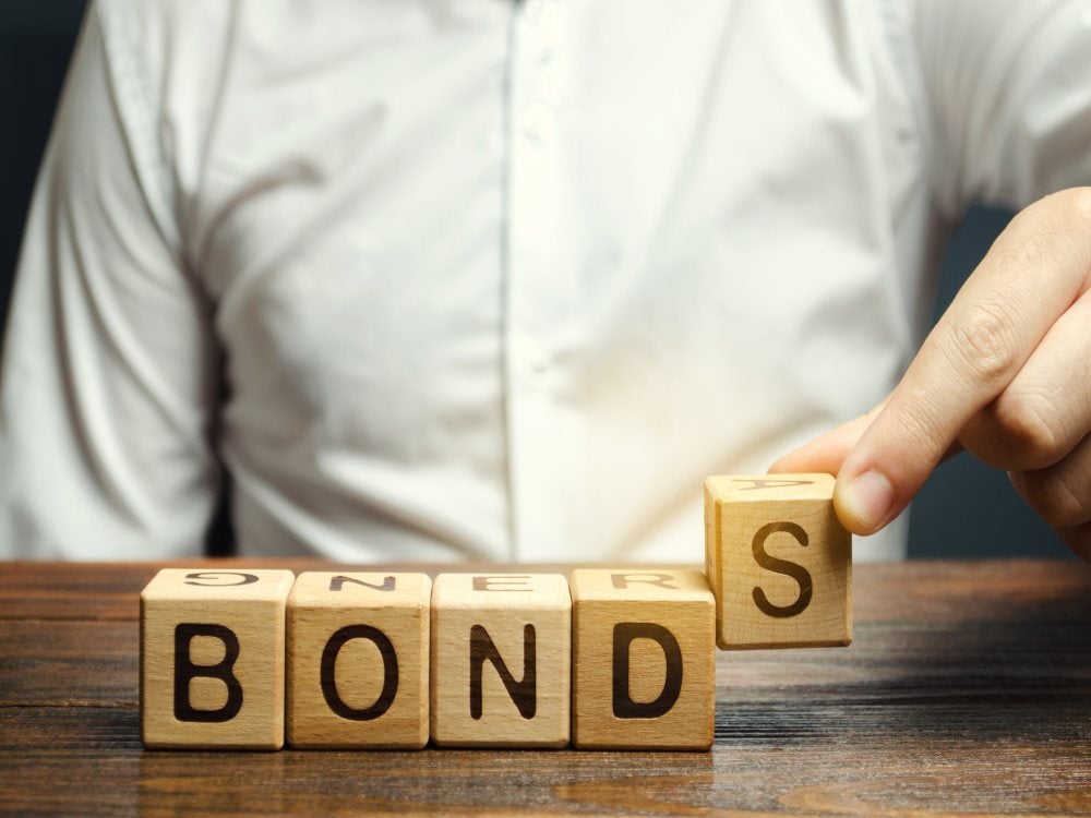 Wooden blocks spelling bonds to represent the bail bond process.